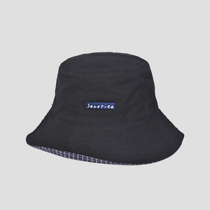 Close-up of black bucket hat featuring a blue Senorita label and checkered lining