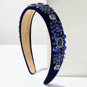 Detailed view of the royal blue velvet headband with intricate blue rhinestone flower motif