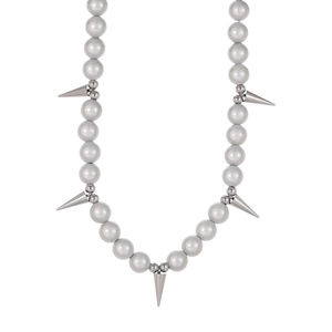 Macro shot of silver pearl necklace with metallic spikes on a clean white background