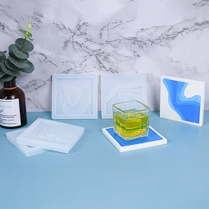 Detailed view of square resin coaster silicone molds with wave texture and blue DIY finished results