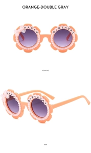 Detail of orange flower kids sunglasses with pearls and Happy Birthday text