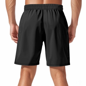 Detail view of men's black quick-dry shorts with elastic waistband and side slit design