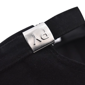 Macro view of the adjustable back strap and matte silver metal buckle with PY engraving