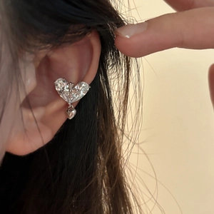 Close-up detail of 18k gold plated zirconia heart ear cuff with gothic cross pendant