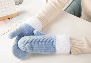 Detailed knit texture of blue mittens with soft white faux fur trim on wrist cuffs