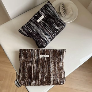 Minimalist striped fabric cosmetic clutch bags with simple wish label on white desk