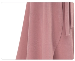 Close-up of pink high-waisted skirt showing textured fabric and elegant drape
