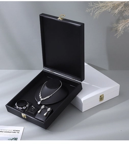 Top view of premium black PU leather jewelry display box with velvet dividers and metal lock