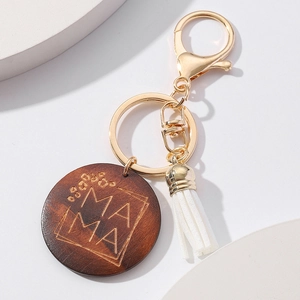 Detail of wooden Mama keychain with leopard engraving, white tassel and golden lobster clasp