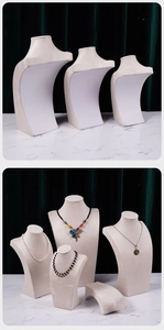 Close-up of beige velvet bust display stands in three sizes for necklace jewelry presentation