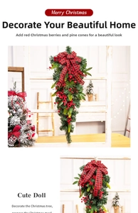 Close-up of Christmas pine swag with red berries, pinecones, and red plaid bow decoration