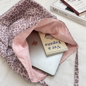 Pink leopard print tote bag interior showing large capacity for laptop and books