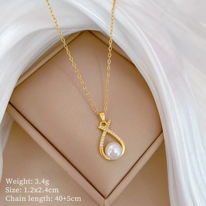 Macro detail of gold necklace with pearl and diamond pendant showing size parameters