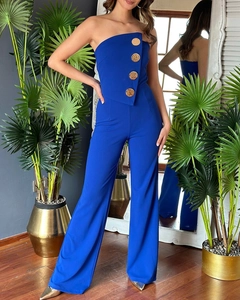 Detail of royal blue strapless jumpsuit featuring elegant gold button accents and a wide leg cut