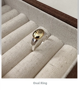Close-up of S925 sterling silver oval ring featuring a contrast gold inset and hallmark