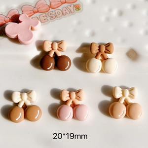 Macro detail of 20x19mm resin cherry bow DIY accessories in neutral earth tones