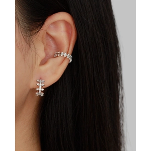 Close-up of sparkling s925 silver ear cuff and earring set with zircon diamonds on model