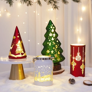 Christmas lanterns with Santa Claus and Reindeer designs on faux snow display