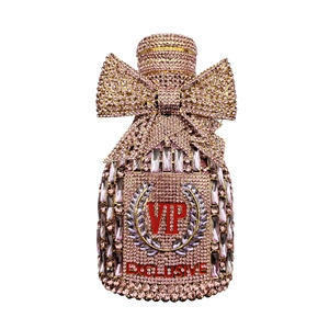 Detail of pink crystal perfume bottle clutch with VIP lettering and metal bow