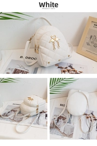 Macro detail of white quilted mini backpack with gold swan pendant and studded accents