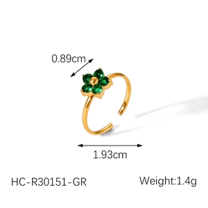 Detail shot of a gold flower ring with green zircon stones showing dimensions 0.89cm