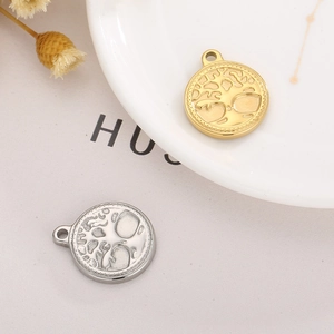 Macro shot of gold and silver Tree of Life pendants with hollow design for DIY jewelry