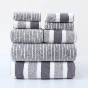 6-piece gray and white towel set with stripes and color blocks stacked on white background