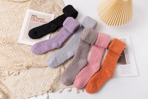 Detailed flat lay of six colorful coral fleece over-knee socks on lace background