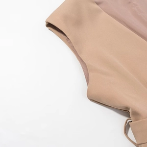 Detailed close-up showing the professional stitching on the shoulder of the khaki vest