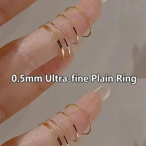 Minimalist ultra-thin 0.5mm gold stacking rings with smooth polished finish for women
