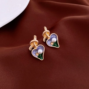 Vintage gold heart earrings with purple enamel, pearls and knot design on velvet
