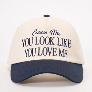 Off-white and navy contrast baseball cap with 'YOU LOOK LIKE YOU LOVE ME' embroidery