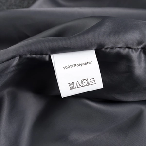 Macro shot of product care label showing 100% polyester material and washing icons