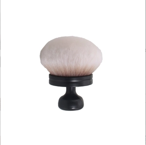 Detail of soft gradient bristles and matte black ergonomic handle on powder brush