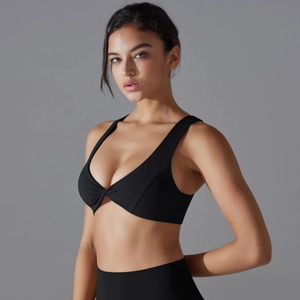 Detailed view of black sports bra featuring a twisted front knot and deep V-neckline