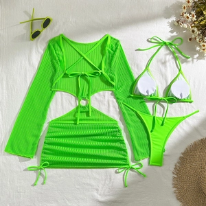 Flat lay of neon green bikini set with sheer mesh cover-up and stylish beach accessories