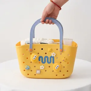 Yellow EVA hollow basket bag with blue handles and colorful cartoon decorative charms