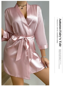 Detail of pink satin silk bathrobe featuring V-neck wrap design and waist tie