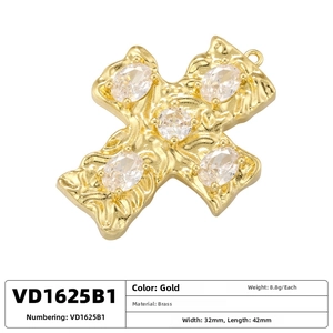 Detailed view of vintage gold brass cross pendant with clear zircons and hammered texture