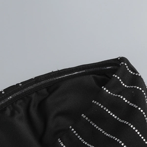 Detailed view of black party dress with wavy silver sequins and non-slip silicone strip