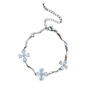 Silver flower heart wave bracelet with zircon and cat eye stone on white background
