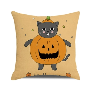 Close-up of linen cushion cover featuring a grey cat in a pumpkin for Halloween