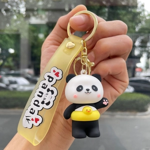 Close-up of cute panda keychain with little duck pattern on a yellow rubber strap
