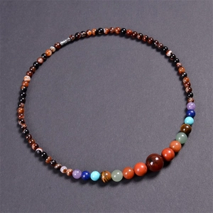 Detailed top view of Bohemian necklace with colorful natural gemstones on dark background