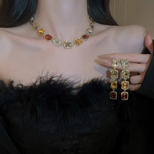 Vintage gold necklace and earrings set with multicolor square crystals on female model