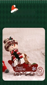 Detail of Christmas snowman figurine sitting in a red metal sleigh with holiday decorations