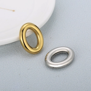 Gold and silver oval stainless steel rings on a light blue textured background