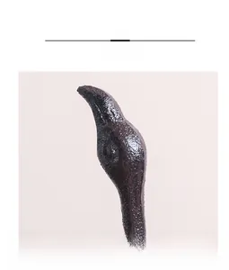 Close-up of cast iron flamingo figurine showing detailed casting texture and bronze finish
