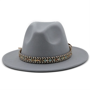 Detail of grey wool fedora hat featuring a colorful ethnic woven band and wide flat brim