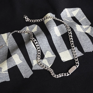 Titanium steel cuban link necklace with minimalist rectangular pendant on black cloth